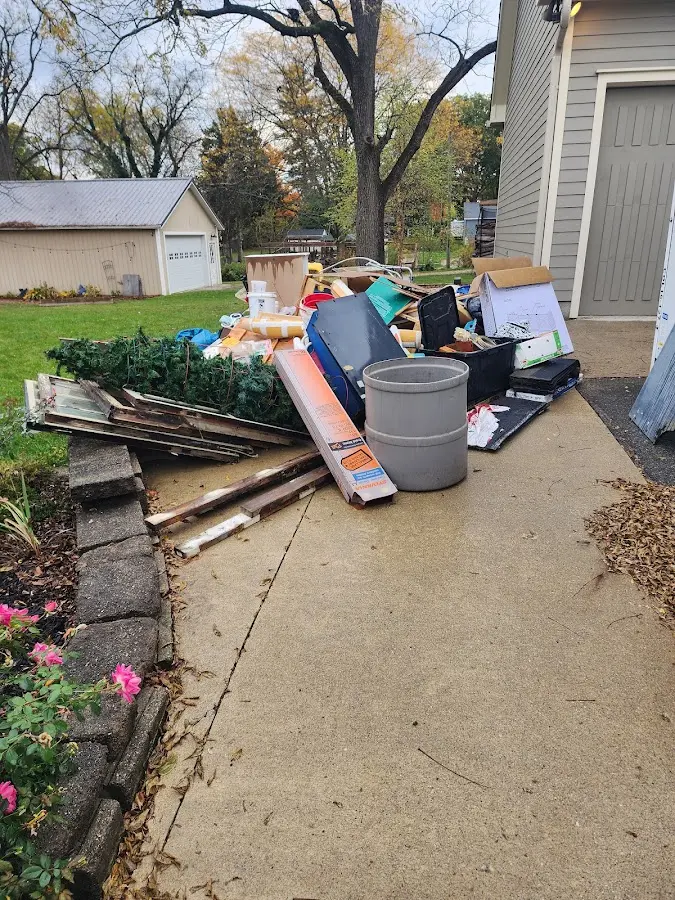 Dumpster being loaded with debris for Estate Cleanout Dumpster Rental in Tinton Falls